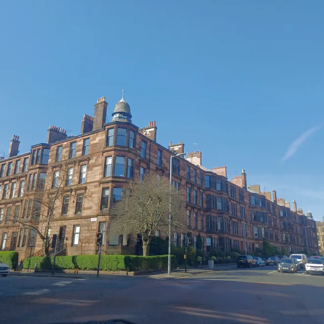 Red sandstone corner tenement with turret in a Glasgow conservation area