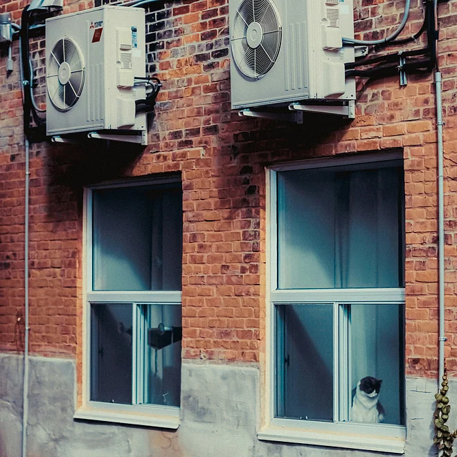 Air source heat pump unit installed on a residential building