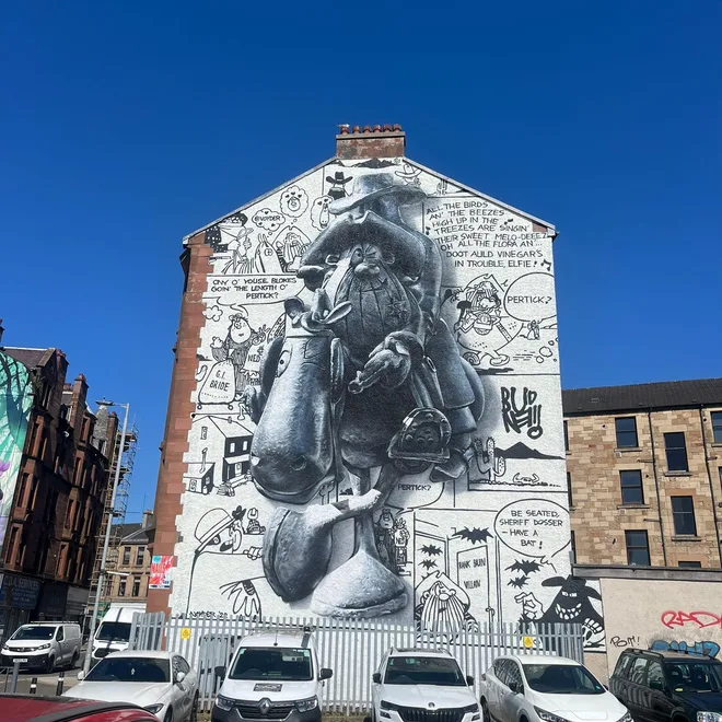 Black and white comic-strip style mural on a Glasgow tenement gable end