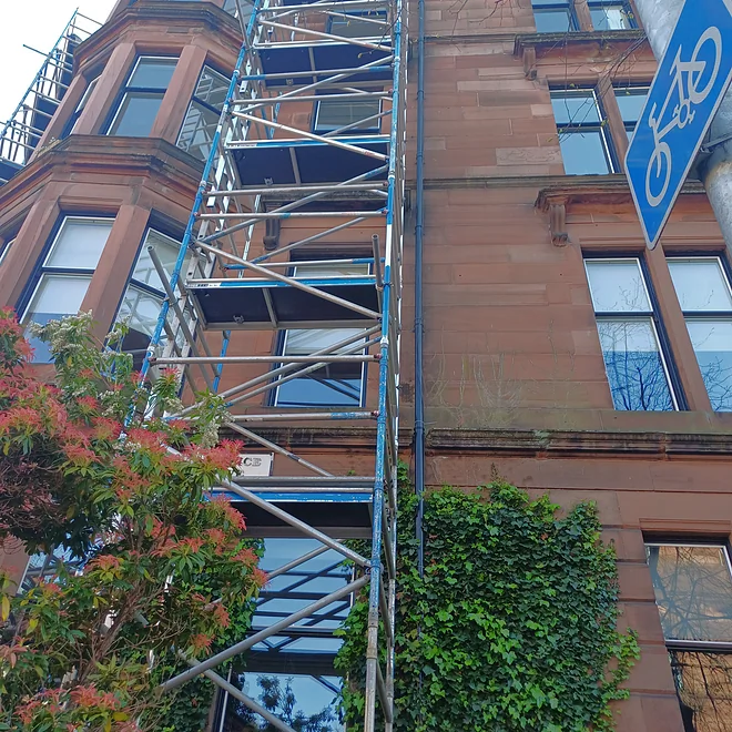 Tenement in Partickhill showing maintenance work with scaffolding and protective sheeting
