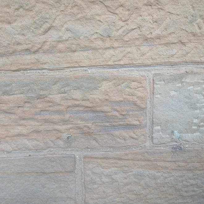 Blonde sandstone showing sedimentary layers where one stone has been laid upside down
