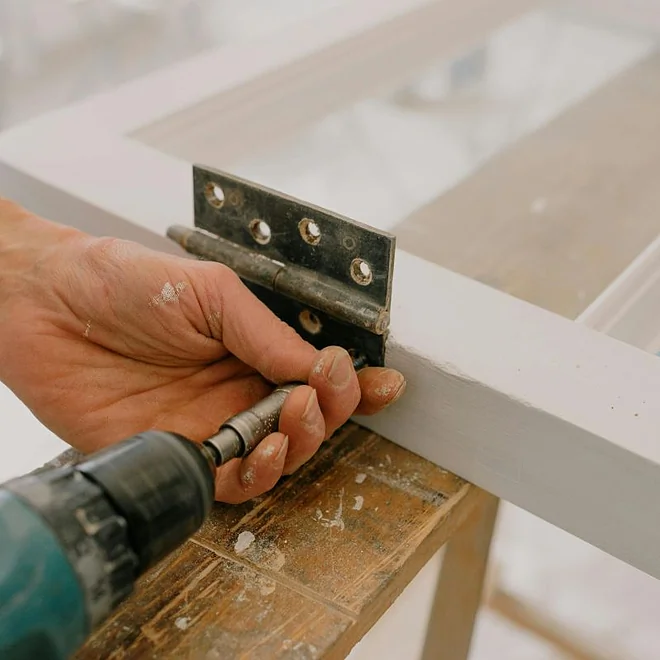 Man restoring sash and case window