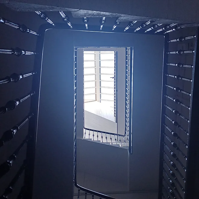 View up a tenement common stair showing the rooflight at the top acting as a ventilation outlet