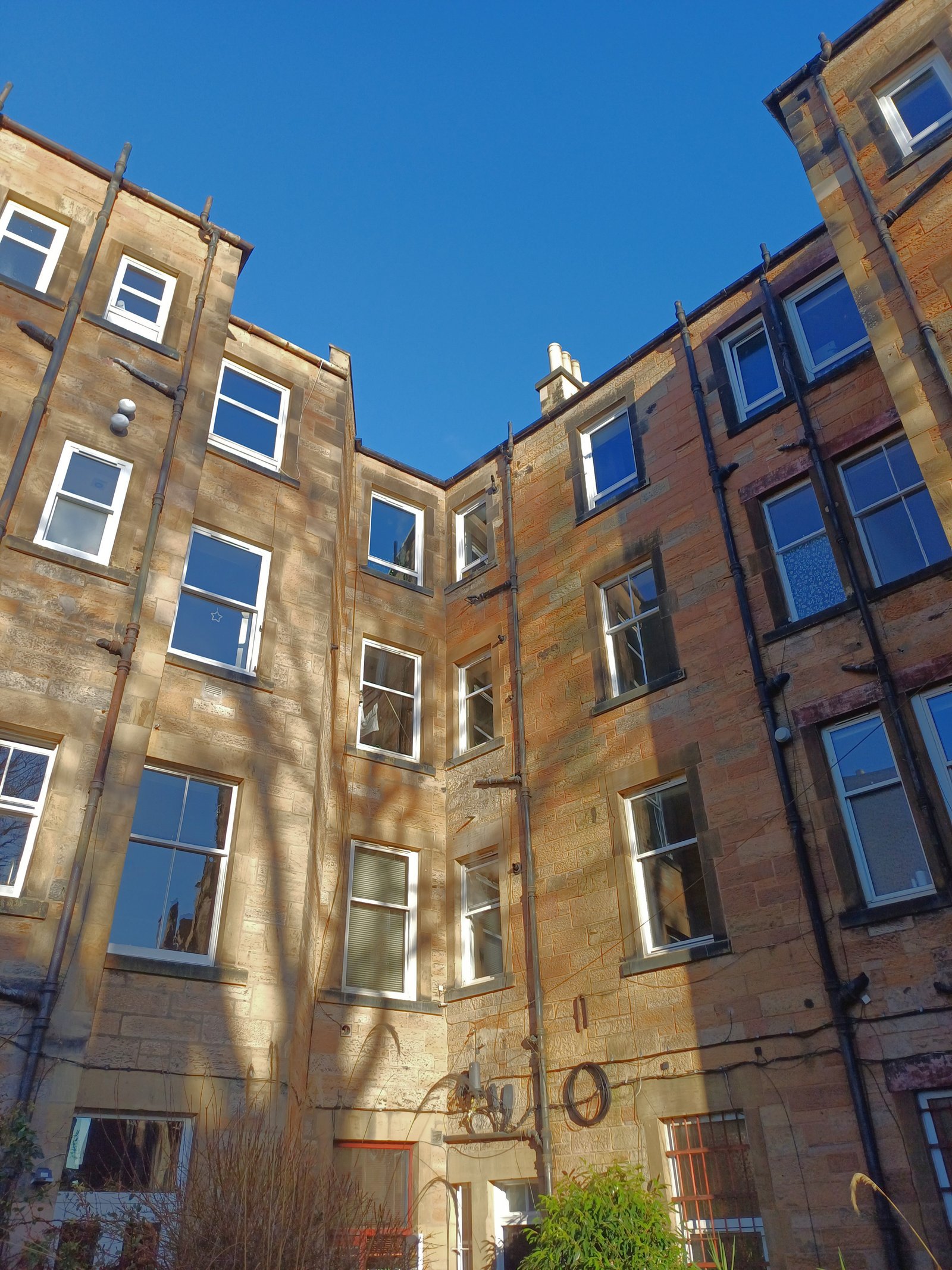 Edinburgh tenement blocks, typical of shared-building stock across the Central Belt